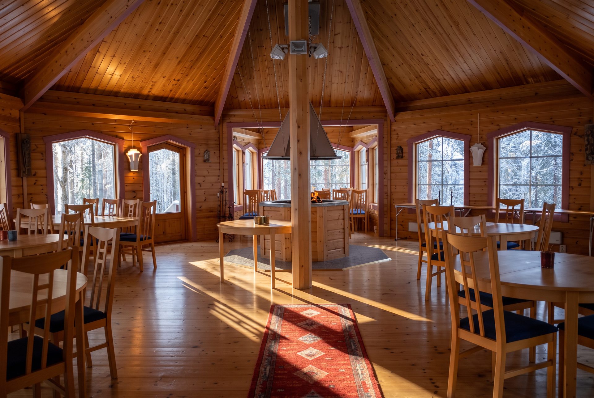 Interiören i Toppstugan med varm belysning och långbord